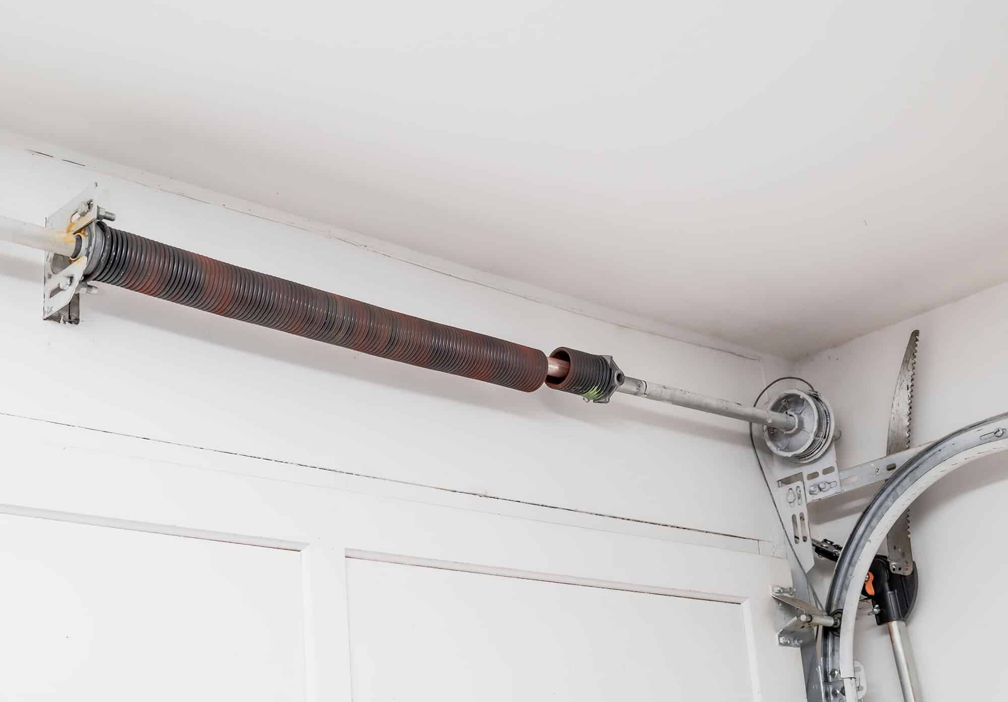 Broken garage door spring repair technician