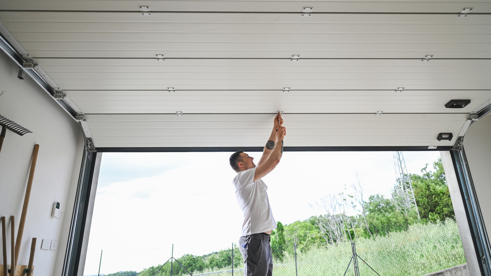 Technician performing garage door tune-up